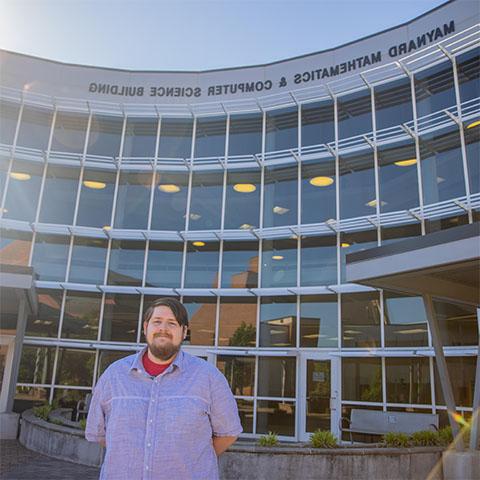 Student standing in front of Maynard 