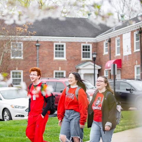 Students walking outside on a spring day.